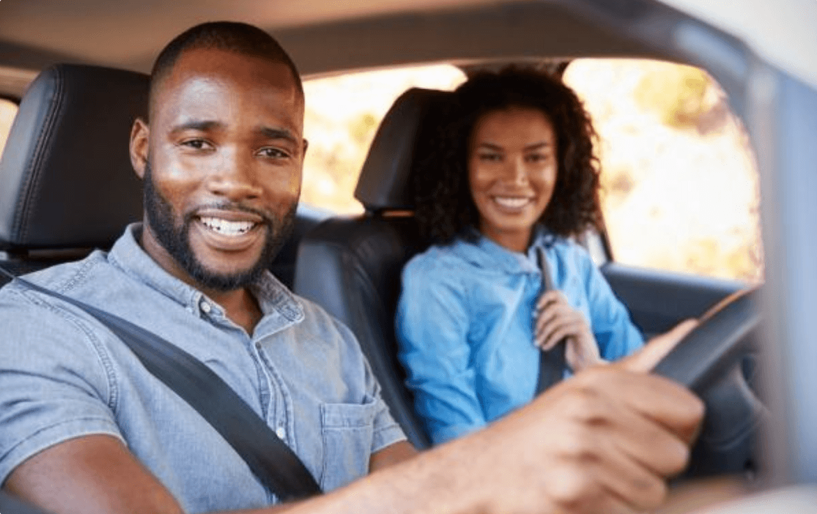 Shield Your Drive To Secure Your Journey image that represents a car with 2 two person, indicated to say shield your drive